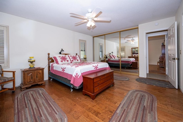 bedroom featuring light wood finished floors, a closet, and a ceiling fan