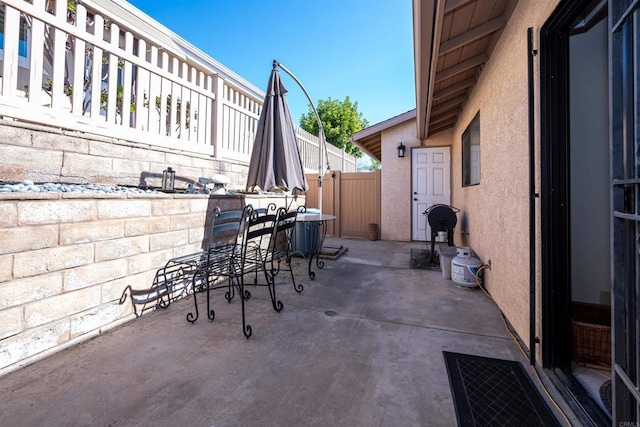 view of patio / terrace with outdoor dining area and fence