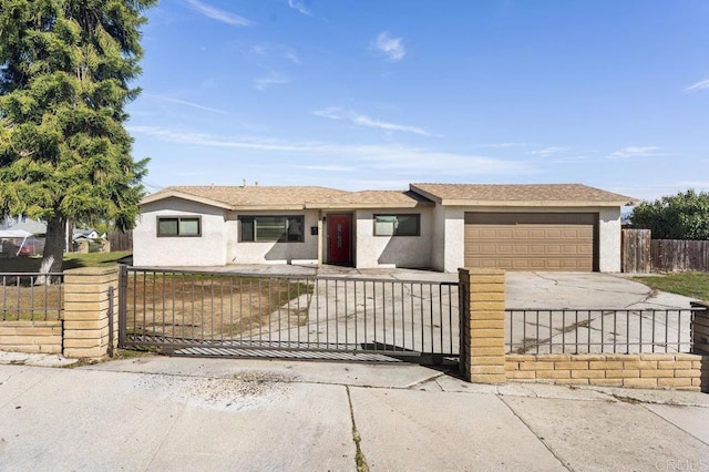 ranch-style house with a garage, concrete driveway, a fenced front yard, and stucco siding