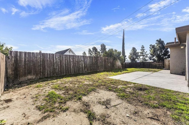 view of yard featuring a patio area and a fenced backyard