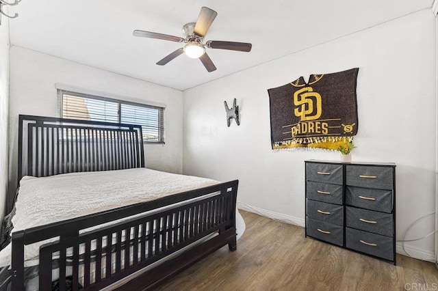 bedroom featuring dark wood-style floors, ceiling fan, and baseboards