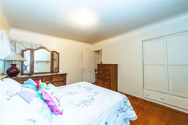 bedroom featuring dark wood-style flooring