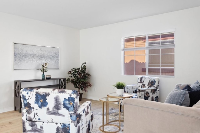 living room with light wood-type flooring and baseboards