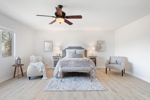 bedroom featuring ceiling fan, light wood finished floors, and baseboards