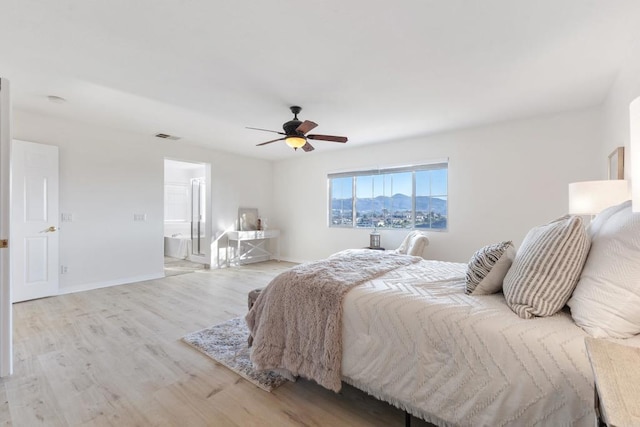 bedroom featuring ceiling fan, visible vents, light wood-style flooring, and baseboards