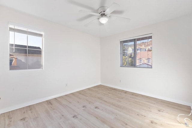 unfurnished room featuring light wood-style floors, baseboards, and a ceiling fan