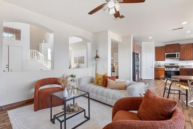 living room with recessed lighting, visible vents, and light wood-style flooring