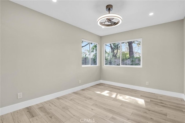empty room with light wood-style floors, recessed lighting, baseboards, and a ceiling fan