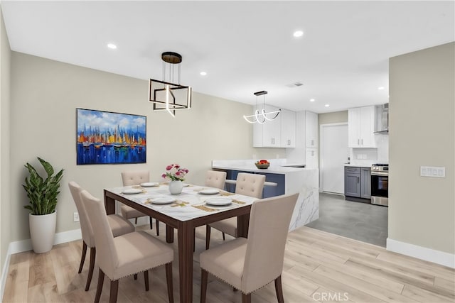 dining space with visible vents, baseboards, light wood-style flooring, and recessed lighting