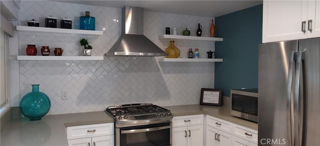 kitchen with open shelves, wall chimney exhaust hood, white cabinetry, and stainless steel appliances