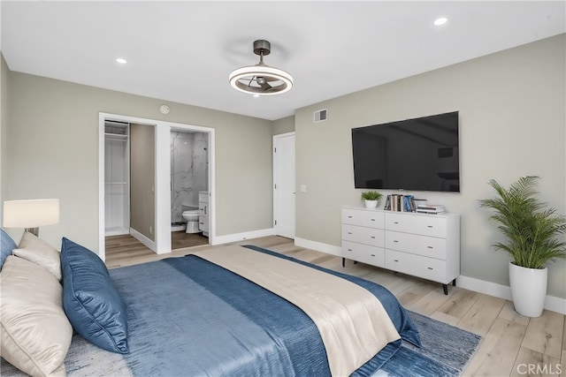 bedroom featuring recessed lighting, visible vents, baseboards, light wood-style floors, and ensuite bath