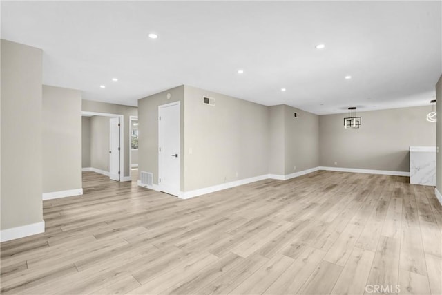 interior space featuring light wood-type flooring, visible vents, baseboards, and recessed lighting