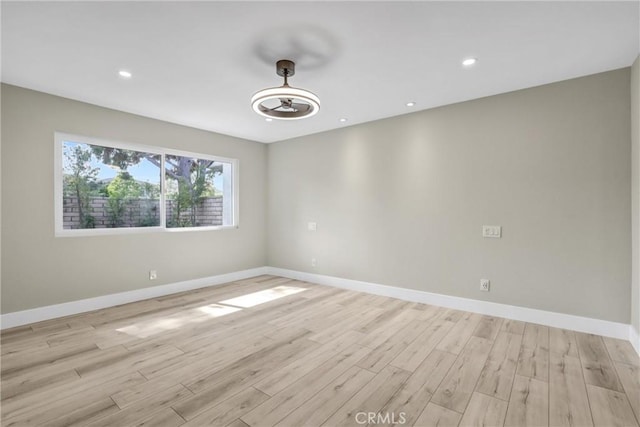 spare room featuring recessed lighting, baseboards, ceiling fan, and light wood finished floors