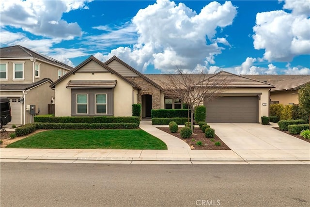 view of front of home featuring an attached garage, concrete driveway, and stucco siding