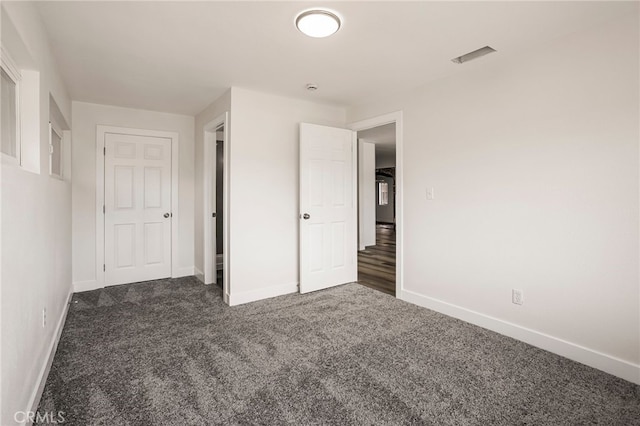 355 French St, Willows, CA 95988 - unfurnished bedroom with baseboards, visible vents, and dark carpet