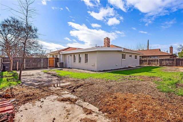 355 French St, Willows, CA 95988 - back of property featuring a patio area, a fenced backyard, a chimney, and a yard