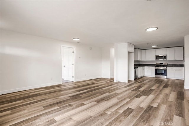 355 French St, Willows, CA 95988 - unfurnished living room with light wood-style flooring and baseboards