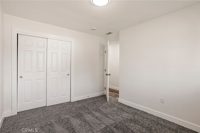 355 French St, Willows, CA 95988 - unfurnished bedroom with a closet, visible vents, dark carpet, and baseboards