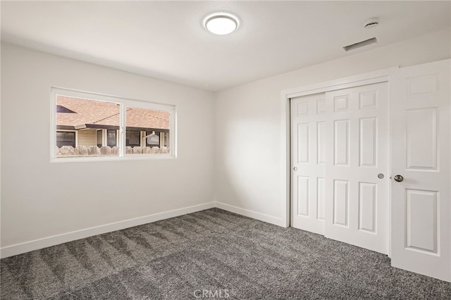 355 French St, Willows, CA 95988 - unfurnished bedroom with a closet, dark carpet, visible vents, and baseboards