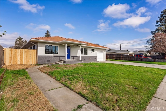 355 French St, Willows, CA 95988 - view of front of property with an attached garage, fence, driveway, a tiled roof, and a front yard