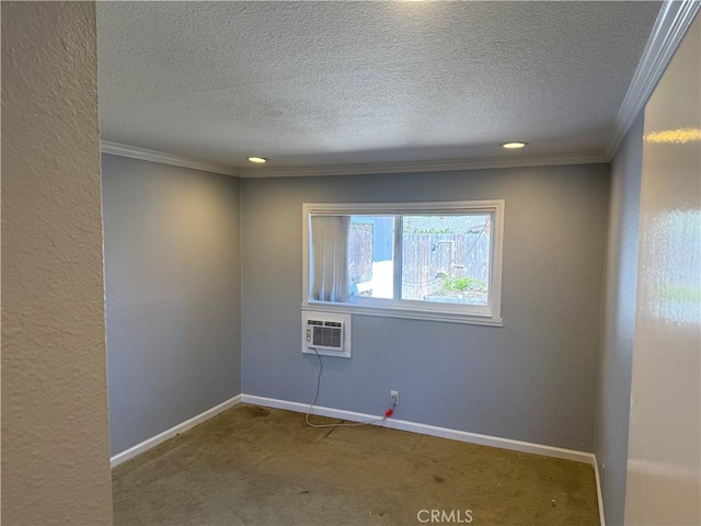 carpeted spare room with baseboards, ornamental molding, a textured ceiling, and a textured wall