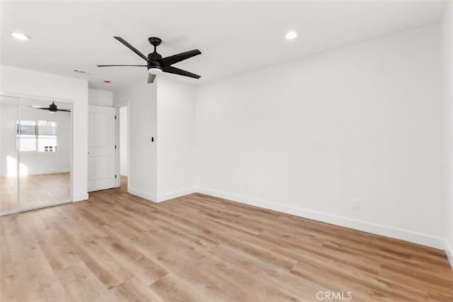 unfurnished bedroom with recessed lighting, light wood-type flooring, and baseboards