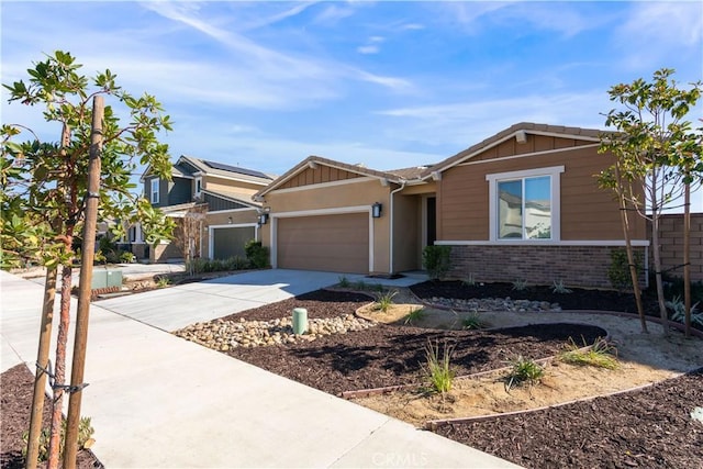 view of front of home with a garage, driveway, and brick siding