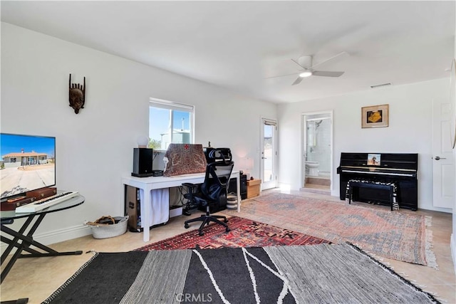 office with baseboards, visible vents, and a ceiling fan