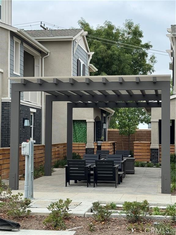 view of patio featuring fence and a pergola