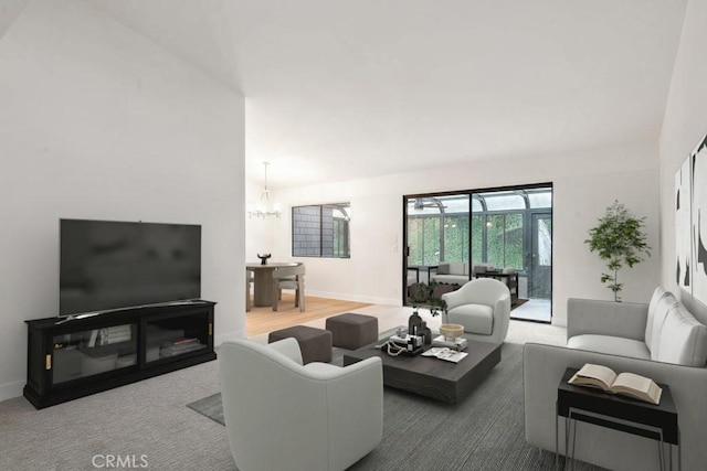 living room featuring a chandelier and baseboards