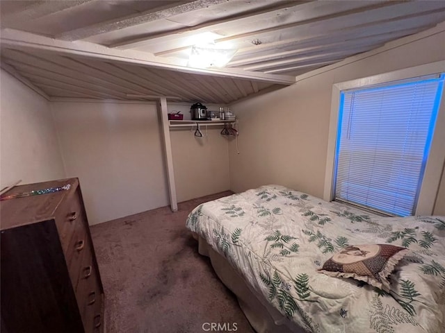 carpeted bedroom featuring lofted ceiling