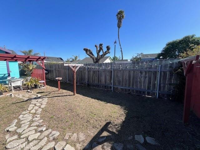 view of yard featuring a fenced backyard and a pergola