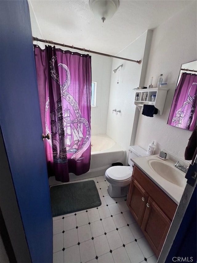 bathroom featuring tile patterned floors, vanity, toilet, and shower / bath combo with shower curtain