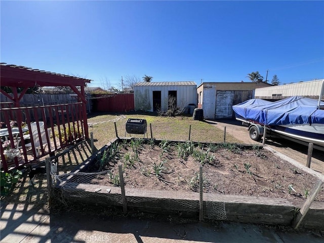 view of yard with fence and an outdoor structure