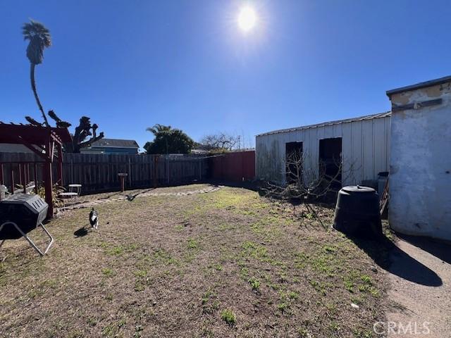 view of yard with fence private yard and an outbuilding