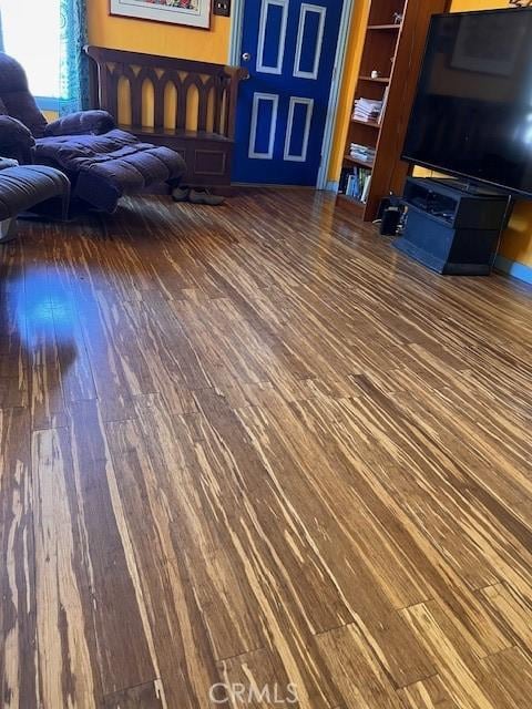 unfurnished living room featuring wood finished floors