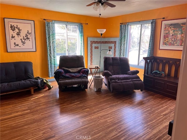 living area featuring a wealth of natural light, ceiling fan, and wood finished floors