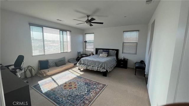 carpeted bedroom featuring visible vents and ceiling fan