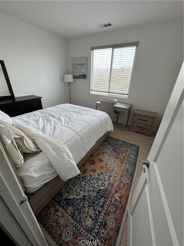 bedroom with visible vents and carpet floors