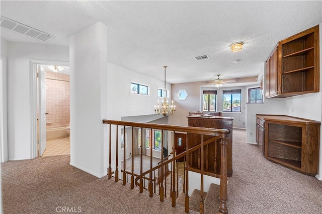 30220 Skippers Way Dr, Canyon Lake, CA 92587 - corridor with light carpet, an upstairs landing, visible vents, and an inviting chandelier