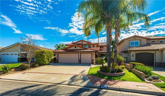 30220 Skippers Way Dr, Canyon Lake, CA 92587 - mediterranean / spanish house featuring a garage, driveway, a tiled roof, and stucco siding