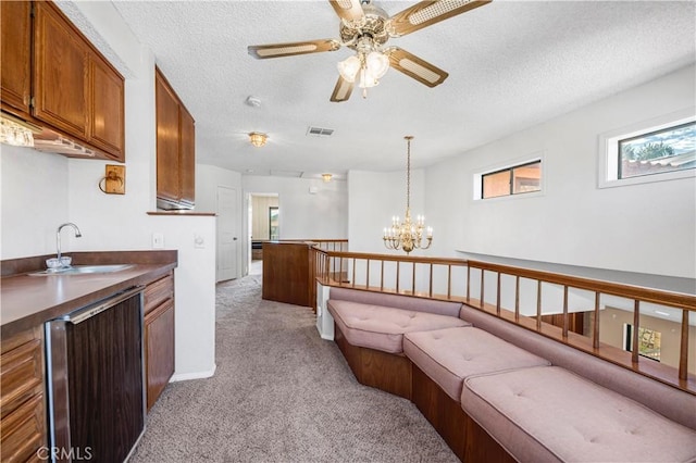 30220 Skippers Way Dr, Canyon Lake, CA 92587 - kitchen with light carpet, visible vents, dark countertops, pendant lighting, and a sink