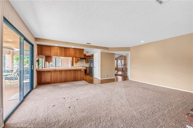 30220 Skippers Way Dr, Canyon Lake, CA 92587 - unfurnished living room with baseboards, a textured ceiling, and light colored carpet
