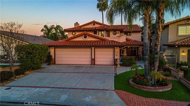 30220 Skippers Way Dr, Canyon Lake, CA 92587 - mediterranean / spanish home with driveway, a chimney, a tiled roof, an attached garage, and stucco siding