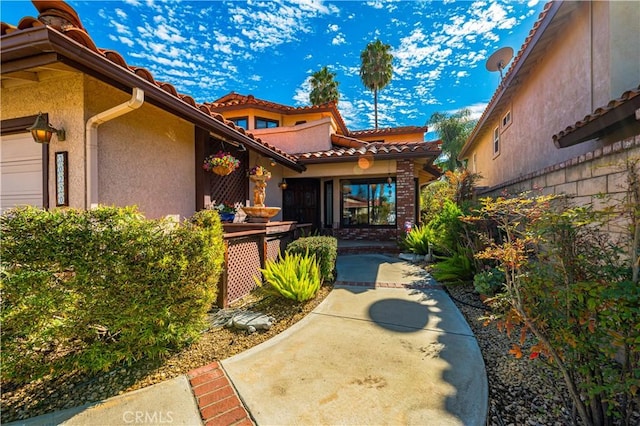 30220 Skippers Way Dr, Canyon Lake, CA 92587 - entrance to property featuring a tiled roof, an attached garage, and stucco siding