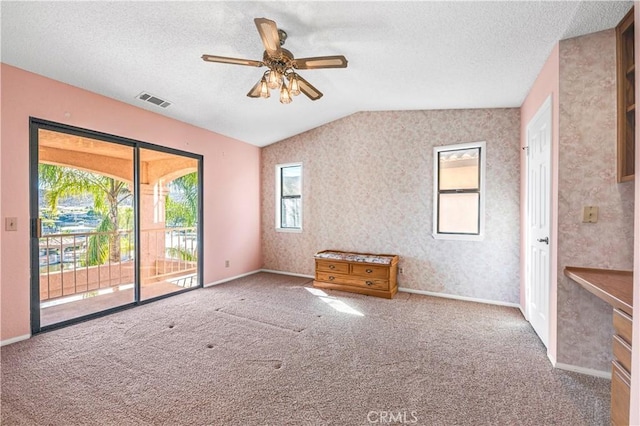 30220 Skippers Way Dr, Canyon Lake, CA 92587 - carpeted empty room with visible vents, vaulted ceiling, a textured ceiling, ceiling fan, and baseboards