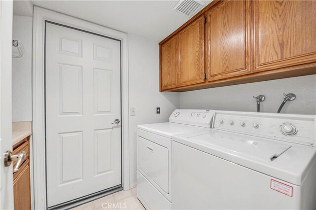 30220 Skippers Way Dr, Canyon Lake, CA 92587 - laundry room featuring visible vents, separate washer and dryer, light tile patterned floors, and cabinet space