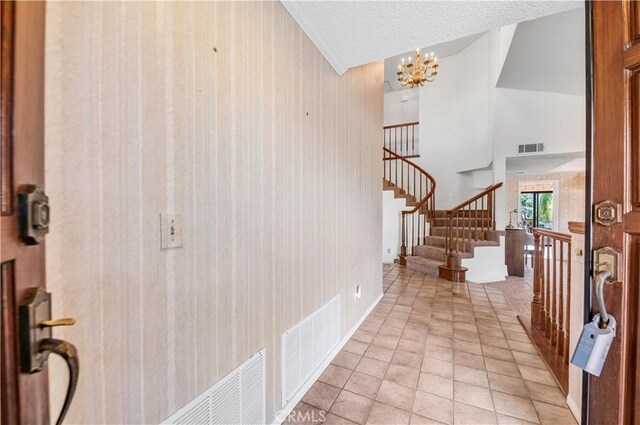 30220 Skippers Way Dr, Canyon Lake, CA 92587 - foyer with a chandelier, light tile patterned floors, stairway, and visible vents
