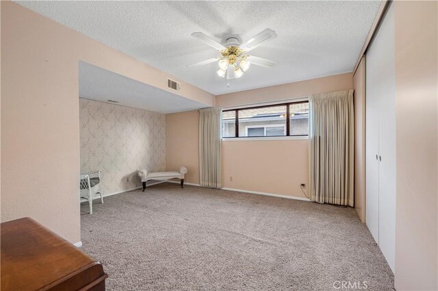 30220 Skippers Way Dr, Canyon Lake, CA 92587 - unfurnished room with a textured ceiling, visible vents, carpet flooring, and a ceiling fan