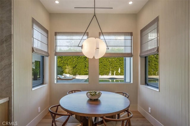 dining space featuring recessed lighting, baseboards, and wood finished floors